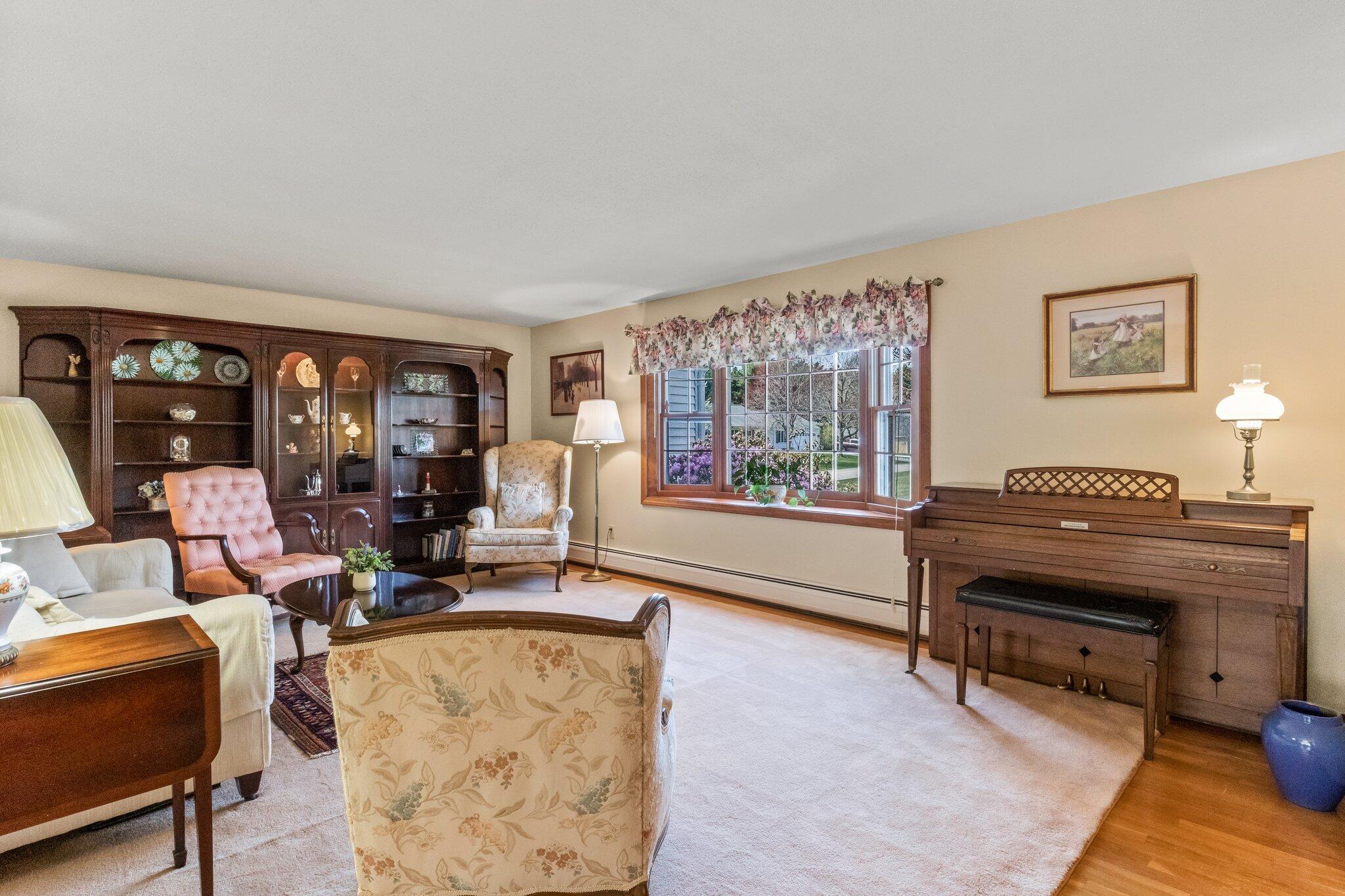 131 Seth Parker Road Centerville, MA 02632 - Photo 10 of 55 a living room with furniture and a piano next to a large window