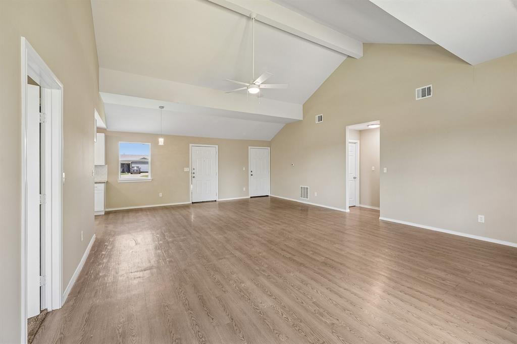 433 Whitney Court Rio Vista, TX 76093 - Photo 6 of 27 an empty room with wooden floor and windows