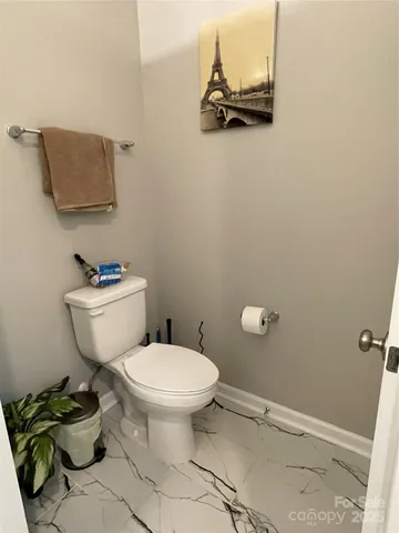a white toilet sitting next to a bathroom sink