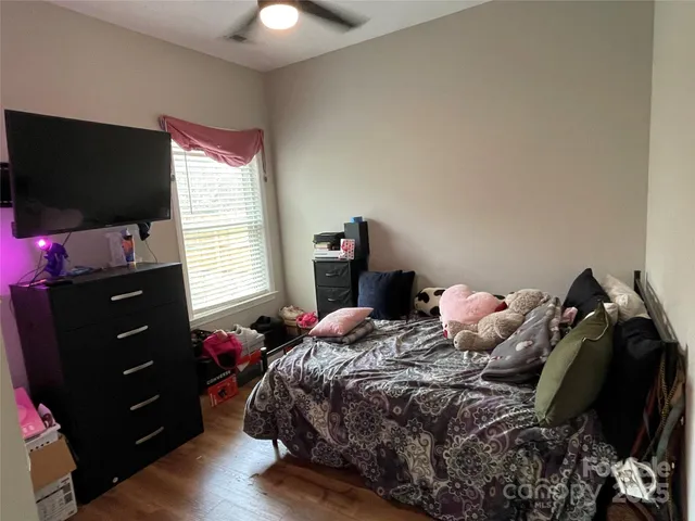 a bedroom with a bed and flat screen tv