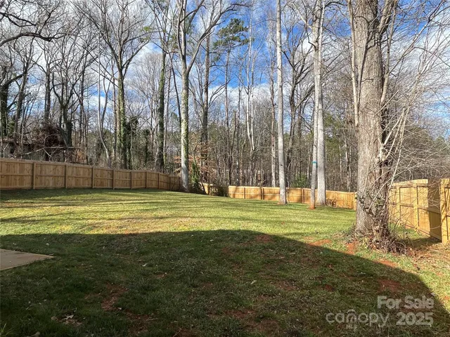 a swimming pool with trees in the background