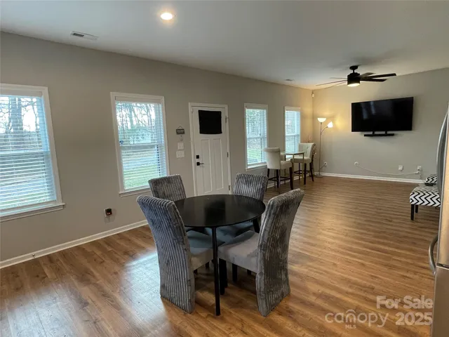 a view of a dining room with furniture and wooden floor