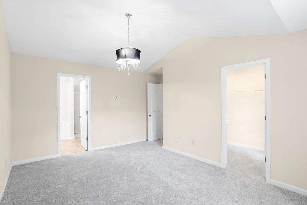 2757 Keystone Avenue Lithonia, GA 30058 - Photo 13 of 28 a view of a hallway with a chandelier fan and windows