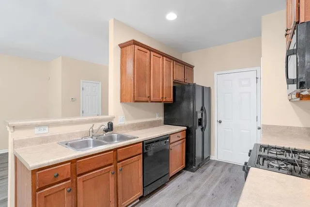 a kitchen with a sink stove and refrigerator