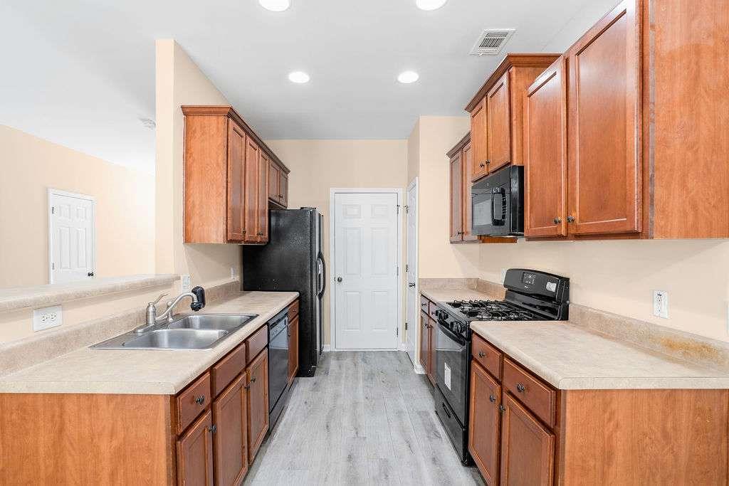 2757 Keystone Avenue Lithonia, GA 30058 - Photo 8 of 28 a kitchen with a sink stove top oven and refrigerator