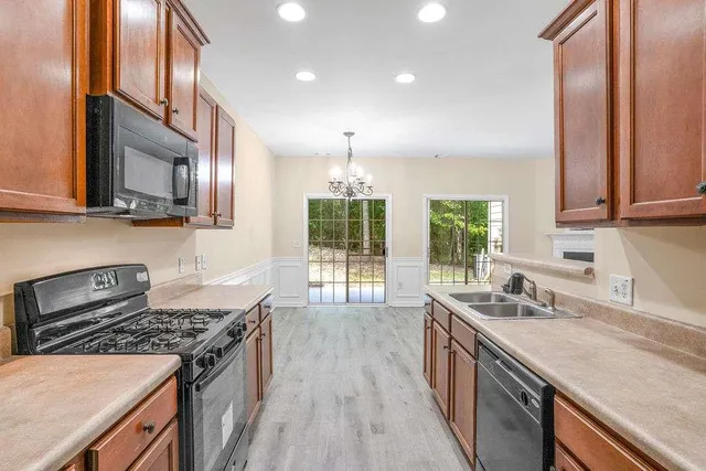 a kitchen with stainless steel appliances granite countertop a stove and a sink