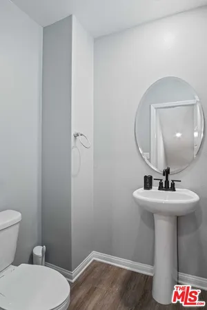 a bathroom with a sink mirror toilet and vanity