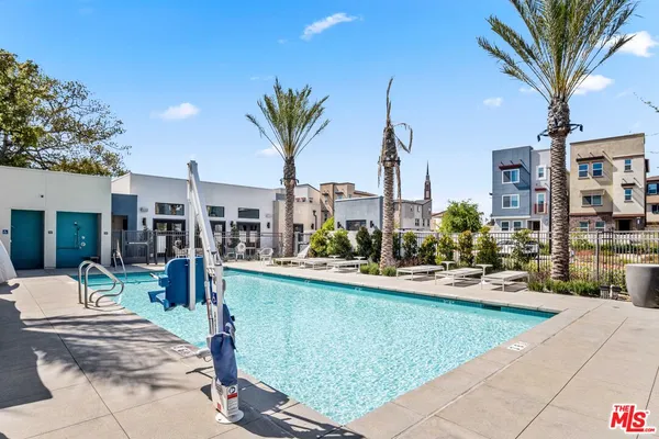 a view of a patio with swimming pool and sitting area