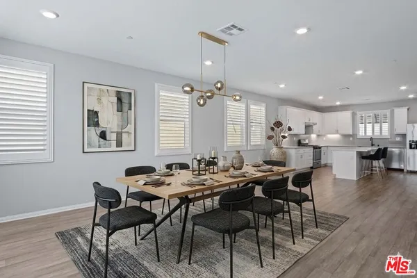 a room with a wooden table and chairs