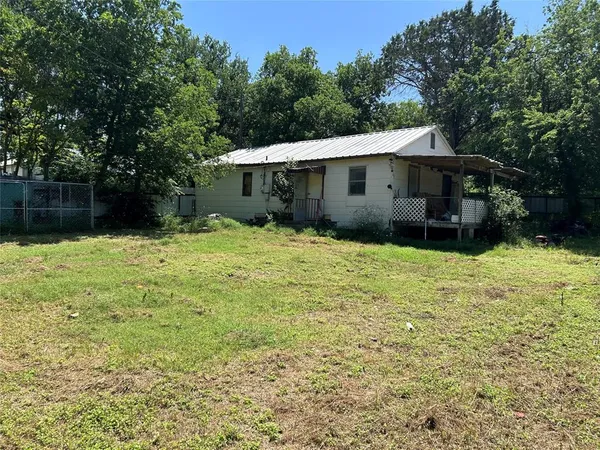 a backyard of a house with yard and trampoline