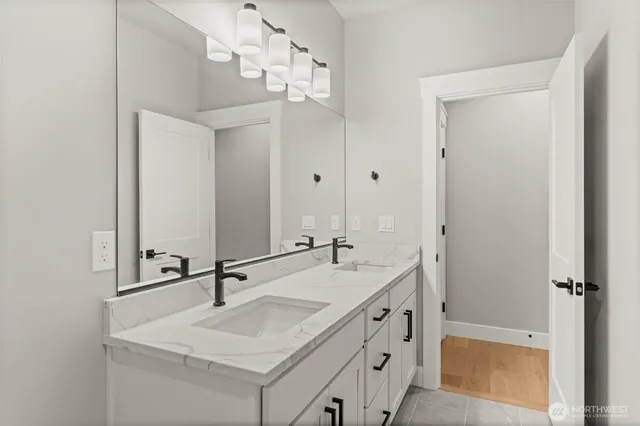 a bathroom with a sink double vanity and a mirror