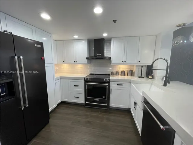 a kitchen with a refrigerator sink and stove