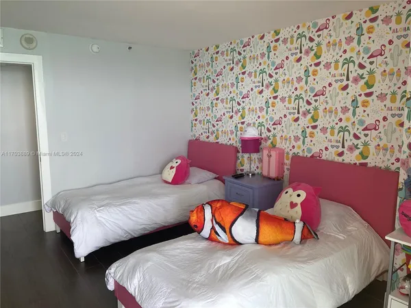 a bedroom with two beds and a lamp