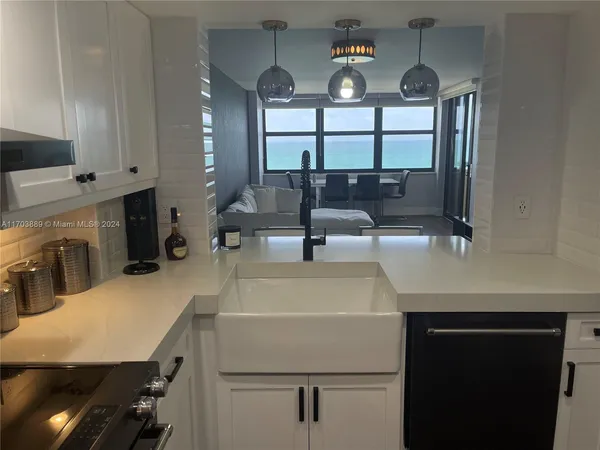 a kitchen with a table chairs refrigerator and cabinets