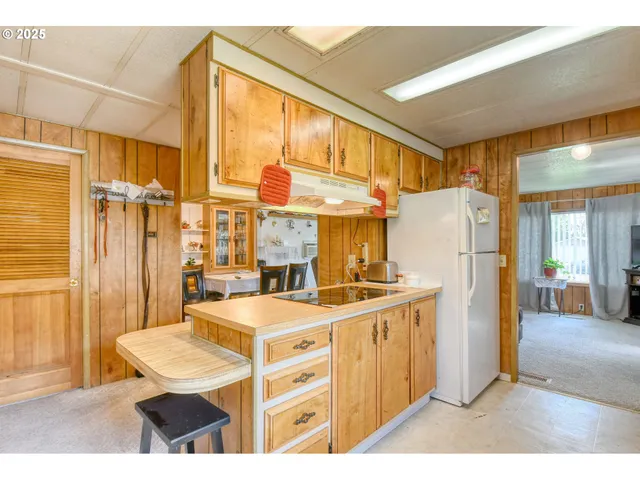 a kitchen with refrigerator cabinets and wooden floor