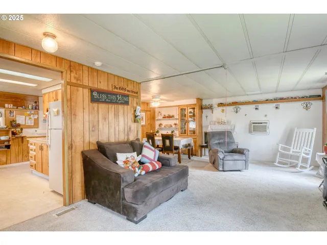 a living room with furniture and a dining table