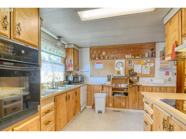 a kitchen with stainless steel appliances a stove top oven