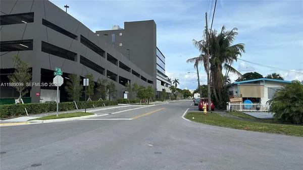 a view of building with car parked