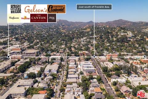 an aerial view of residential houses with street