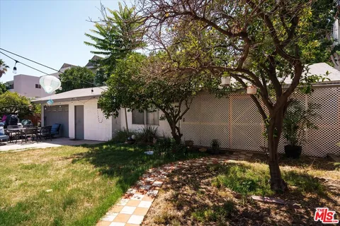 a view of a house with yard and tree s