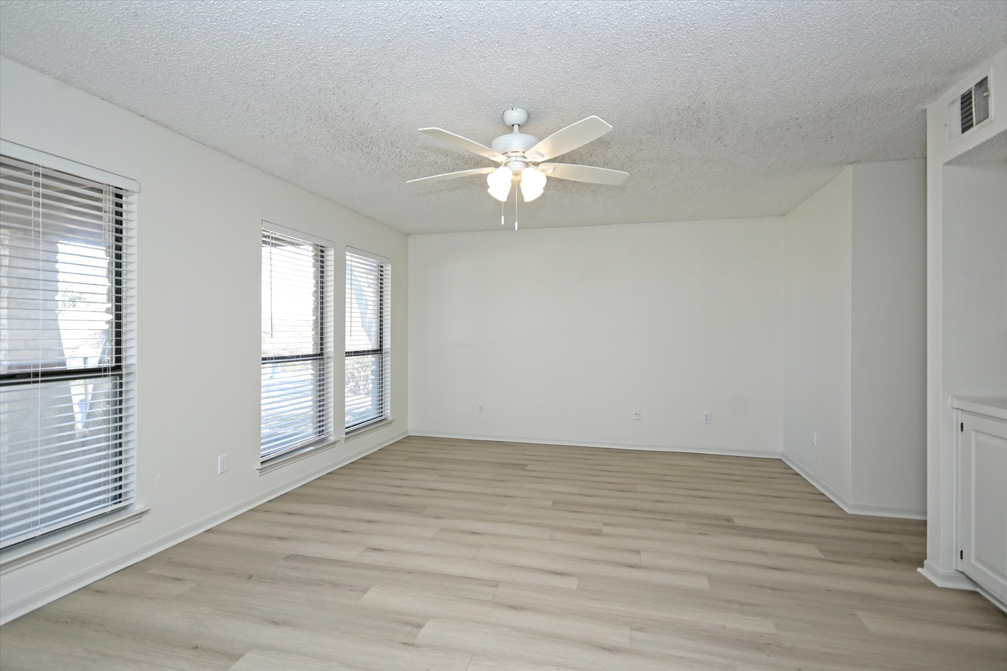 105 Crescent Bluff Austin, TX 78734 - Photo 11 of 28 wooden floor in an empty room with a window