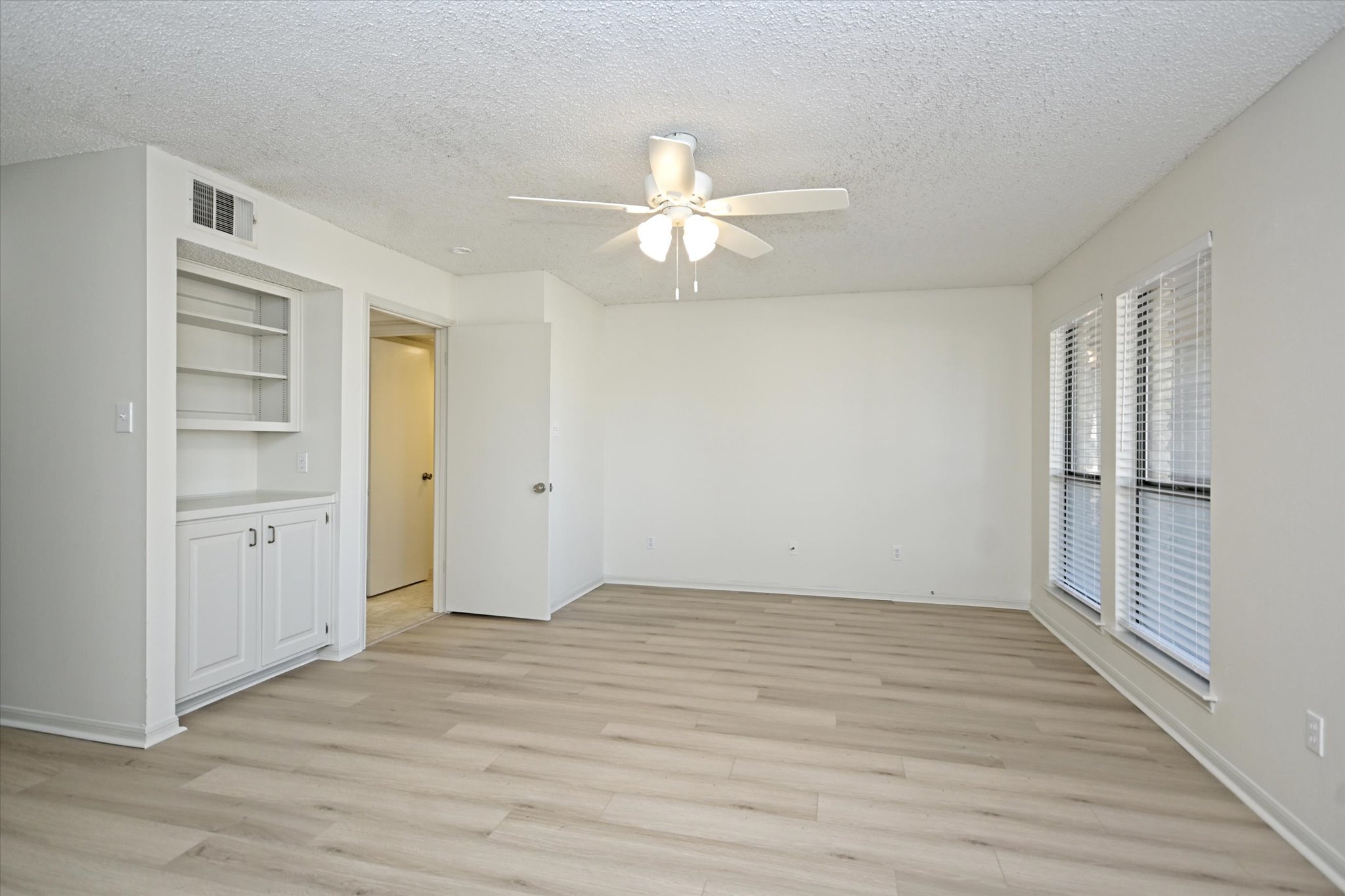 105 Crescent Bluff Austin, TX 78734 - Photo 12 of 28 wooden floor in an empty room with a window