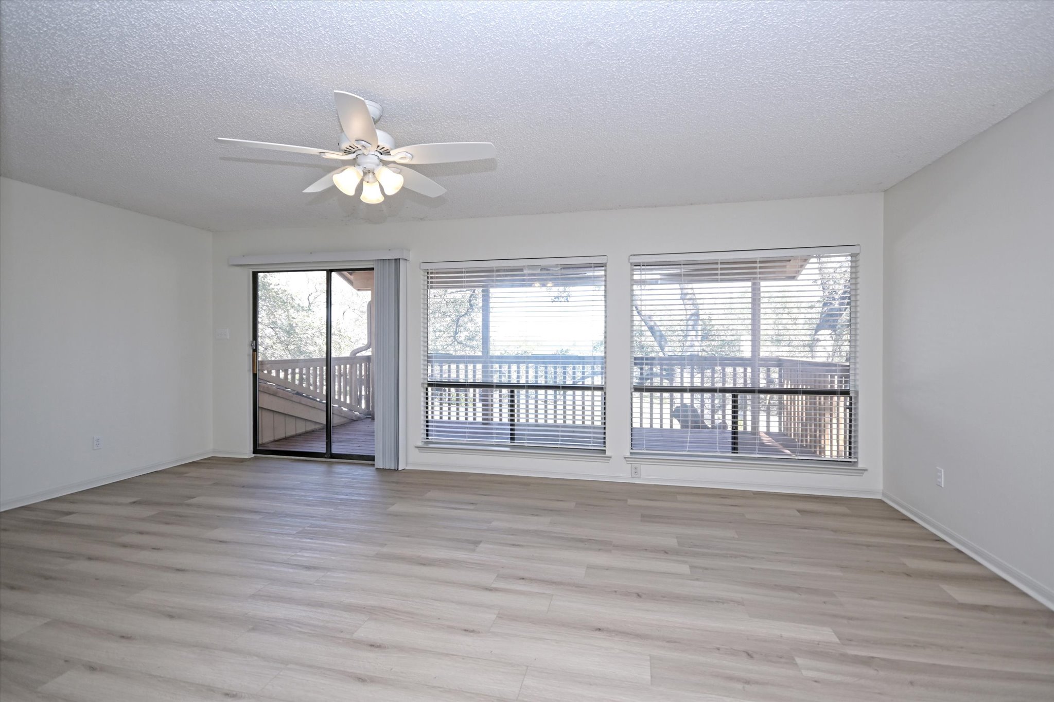 105 Crescent Bluff Austin, TX 78734 - Photo 16 of 28 wooden floor in an empty room with a window