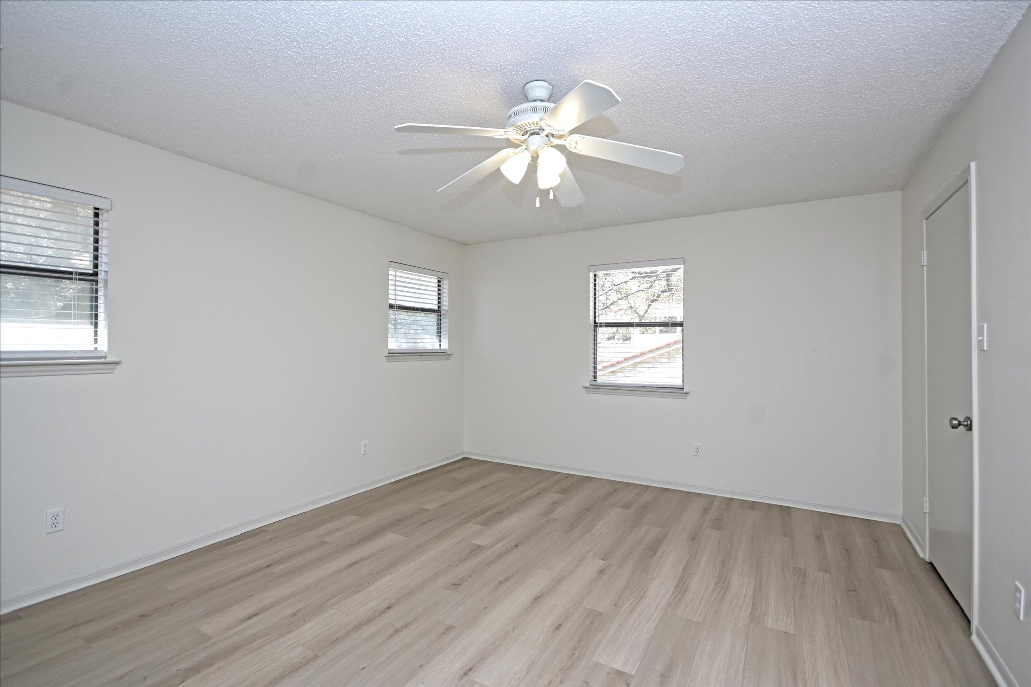 105 Crescent Bluff Austin, TX 78734 - Photo 19 of 28 a view of an empty room with wooden floor and a window