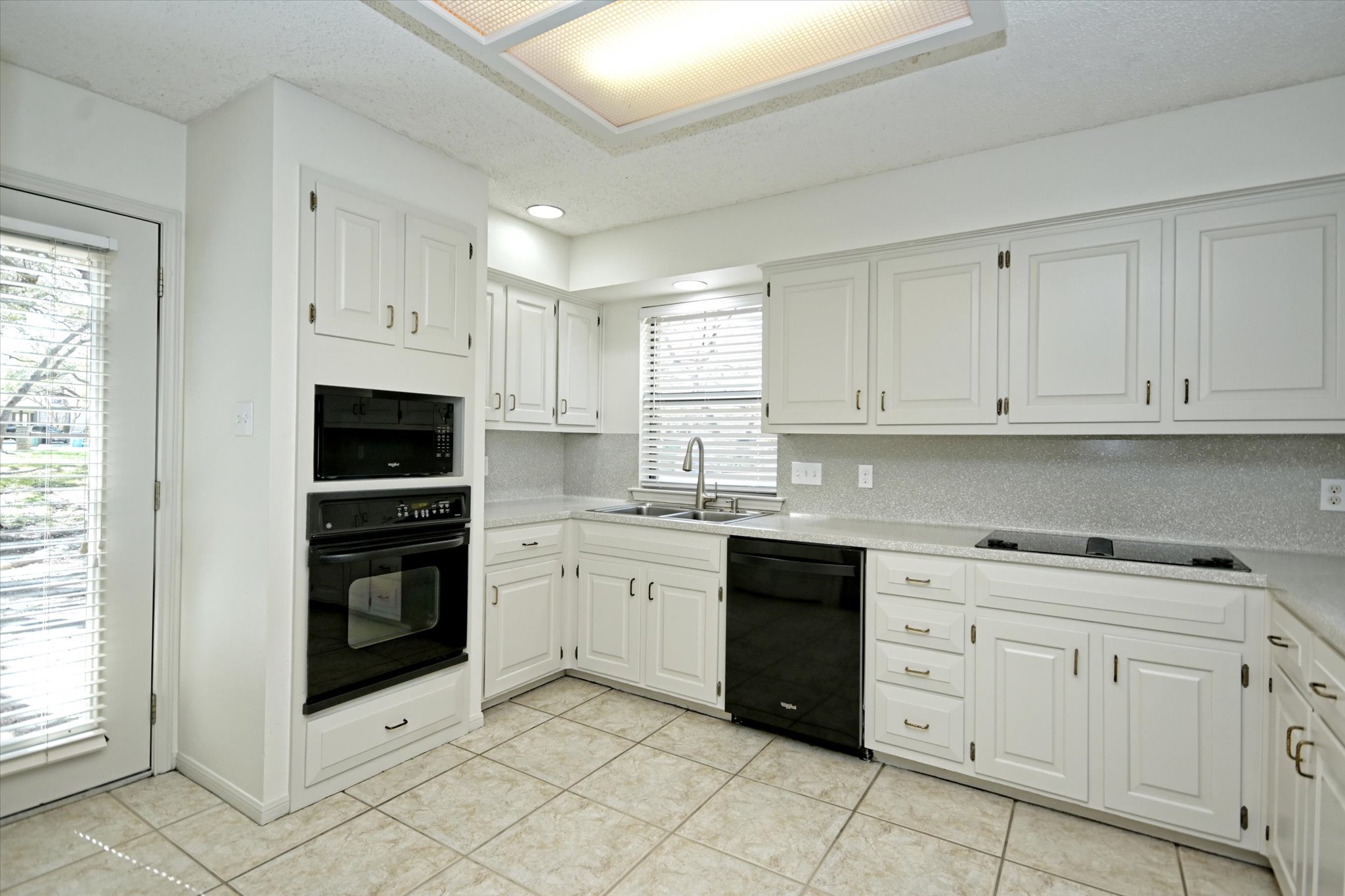 105 Crescent Bluff Austin, TX 78734 - Photo 7 of 28 a kitchen with white cabinets and appliances