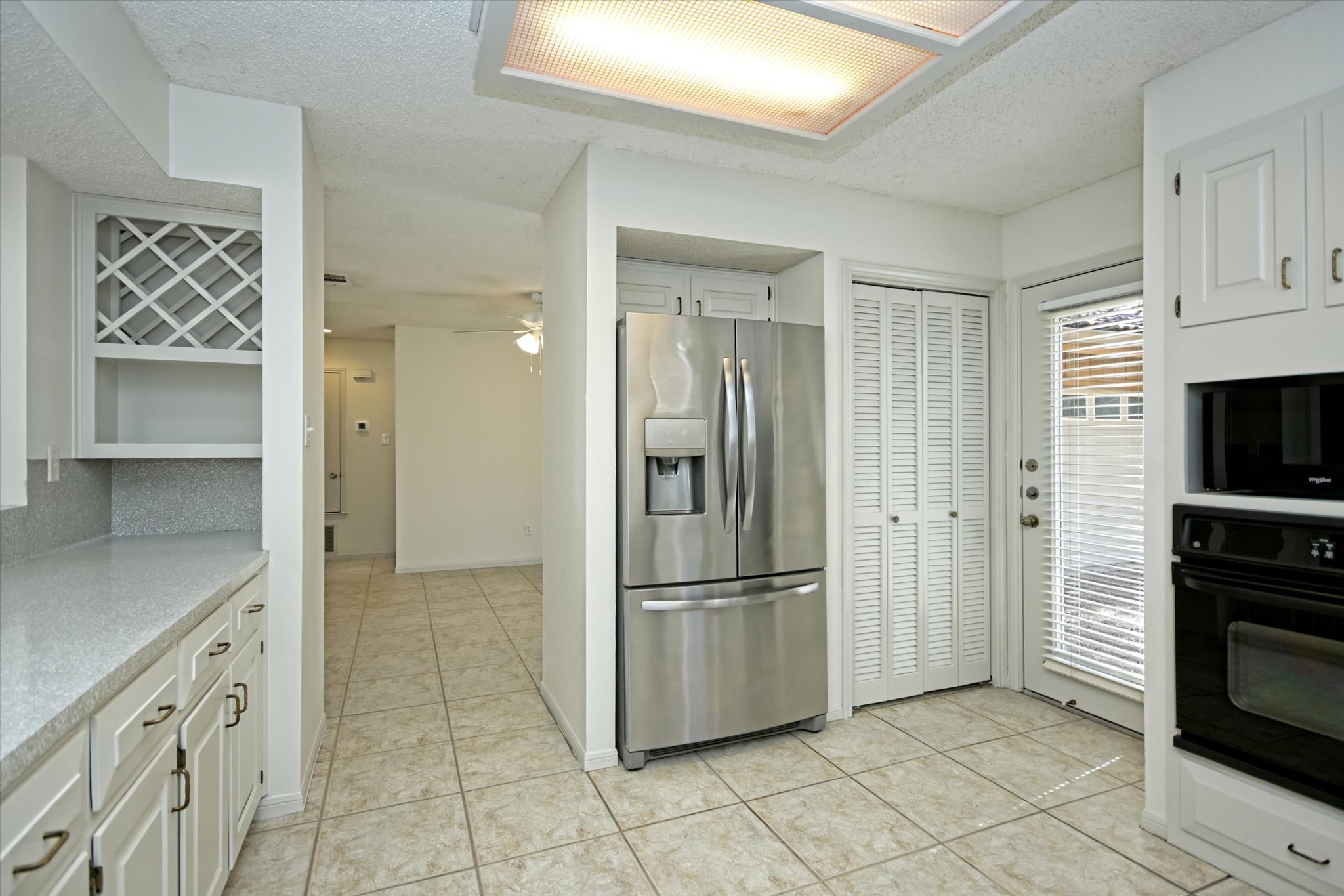 105 Crescent Bluff Austin, TX 78734 - Photo 8 of 28 a kitchen with granite countertop a refrigerator and a stove top oven