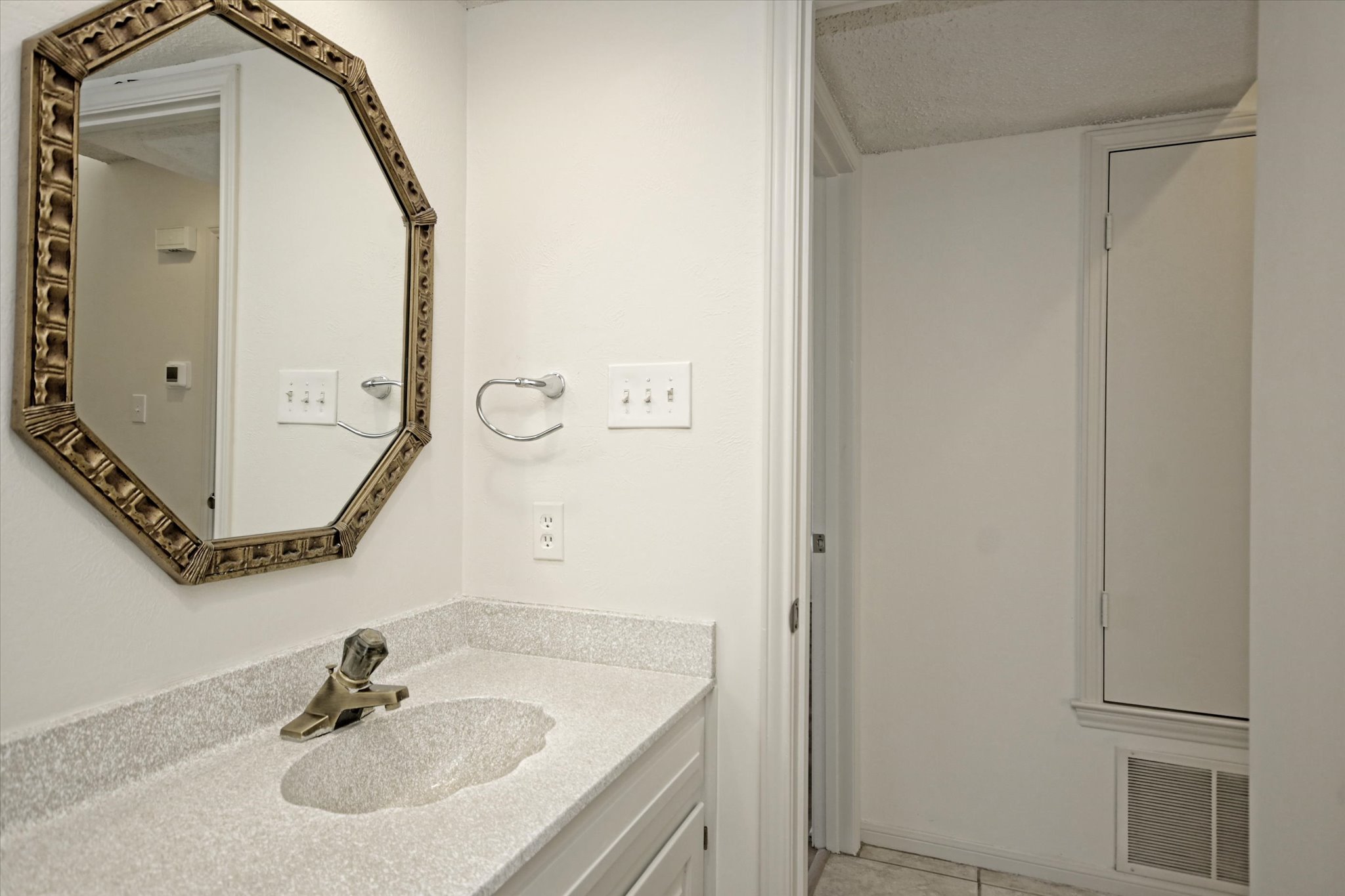 105 Crescent Bluff Austin, TX 78734 - Photo 10 of 28 a bathroom with a sink and a mirror