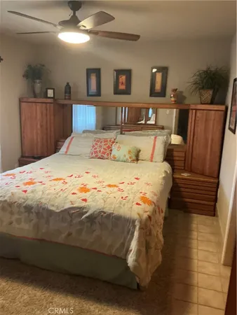 a bedroom with a bed and a view of kitchen