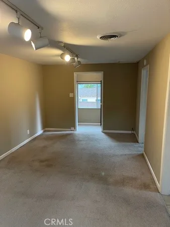 a bedroom with a bed and a mirror