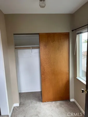 a bedroom with a bed and a chair
