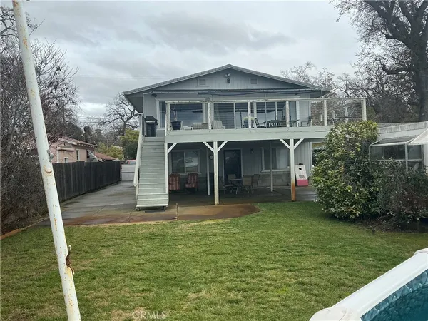 a view of a house with backyard and porch