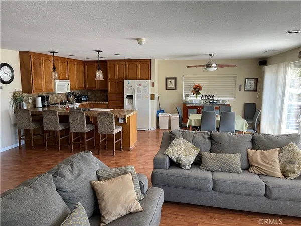 a living room with furniture dining area and a window