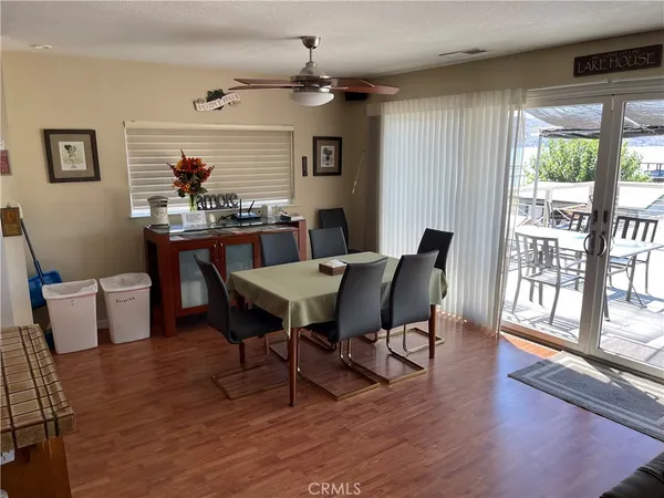 a view of a dining room with furniture wooden floor and a chandelier