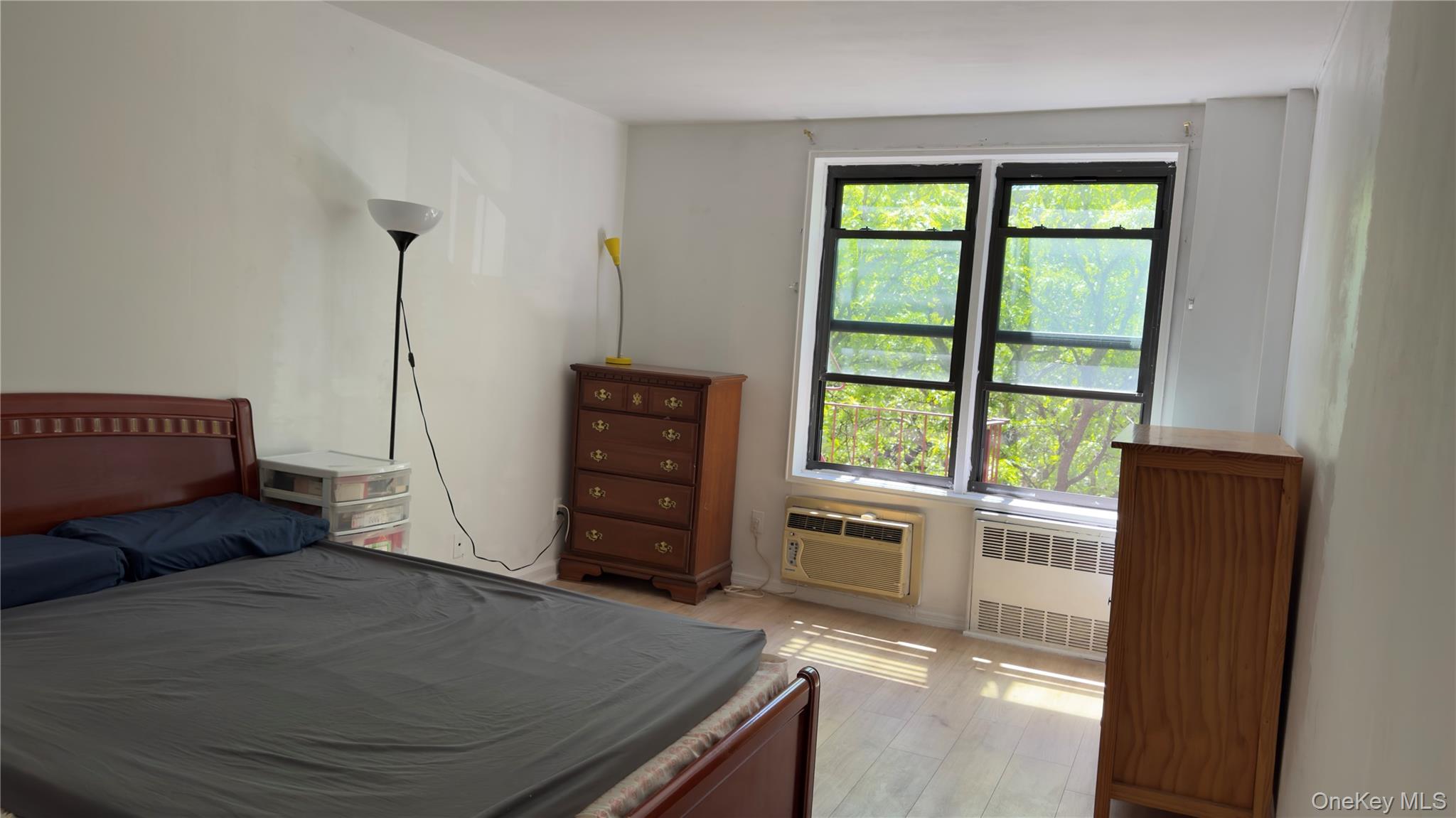 58-03 Calloway Street, Unit 4H Queens, NY 11368 - Photo 4 of 10 a living room with furniture and a window