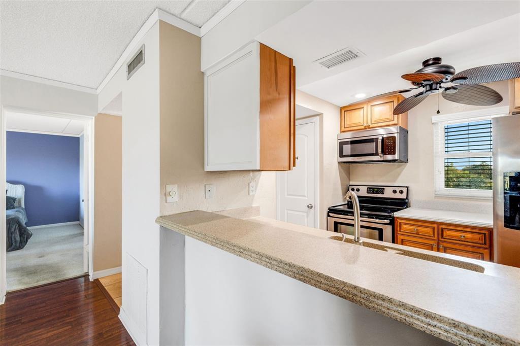 12760 Indian Rocks Road, Unit 119 Largo, FL 33774 - Photo 11 of 24 a kitchen with stainless steel appliances granite countertop a sink and a stove top oven