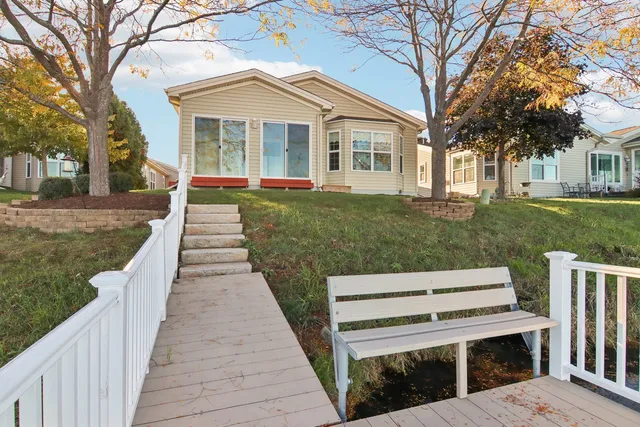 a view of a house with a yard and a fountain