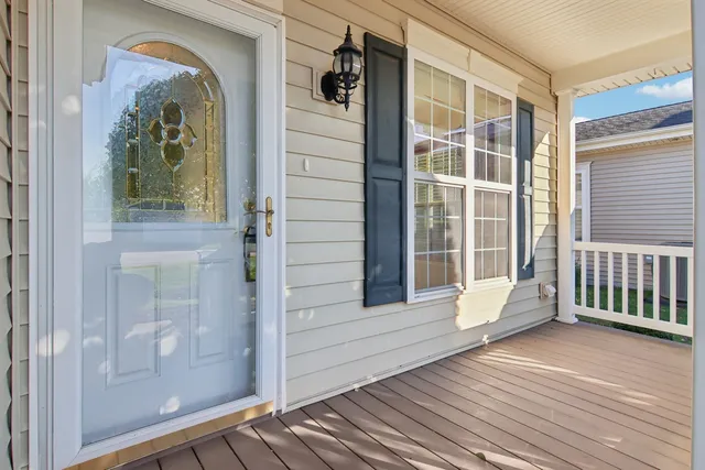 a living room with furniture a fireplace and a floor to ceiling window