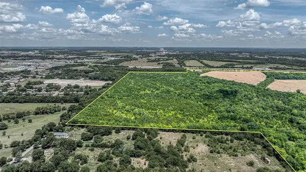 an aerial view of residential houses with outdoor space and swimming pool