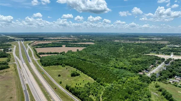 a view of a field with an ocean