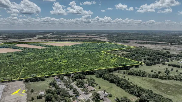 a view of a lake with a big yard and potted plants