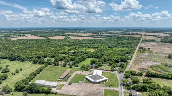 an aerial view of ocean with residential houses with outdoor space and seating