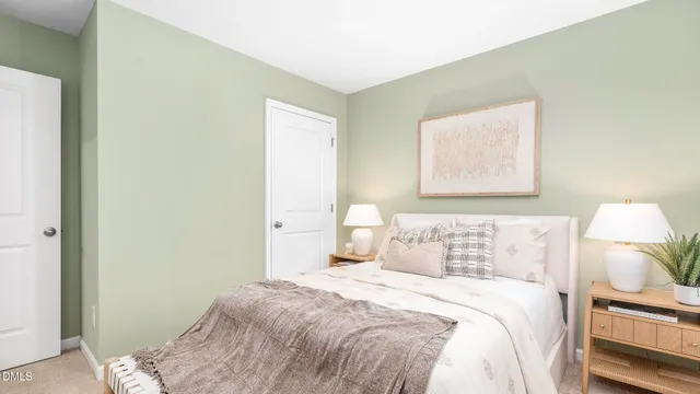 a spacious bedroom with a large bed and a potted plant