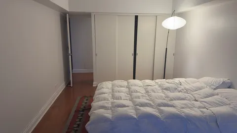 a bedroom with a bed and a chandelier fan