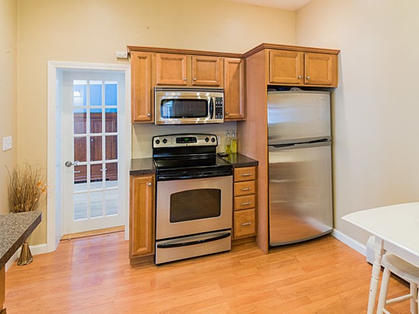 10 Metropolitan Avenue Ashland, MA 01721 - Photo 14 of 22 a kitchen with stainless steel appliances a stove microwave and refrigerator