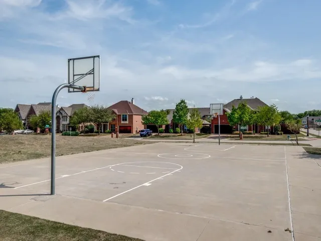 a front view of a house with a yard and potted plants