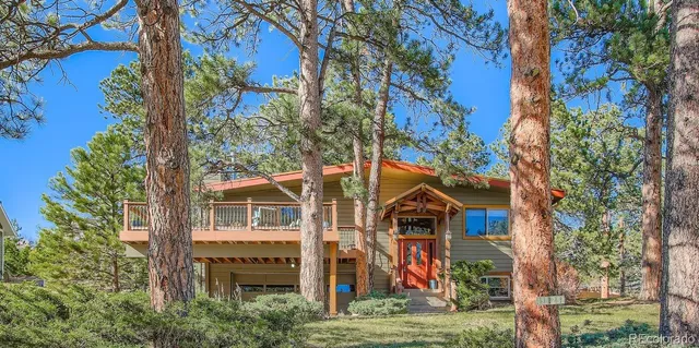 front view of a house with a tree